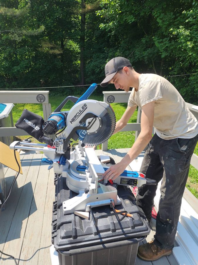 Bryce using a miter saw on the job — Brutus's Handyman Services Central Maine